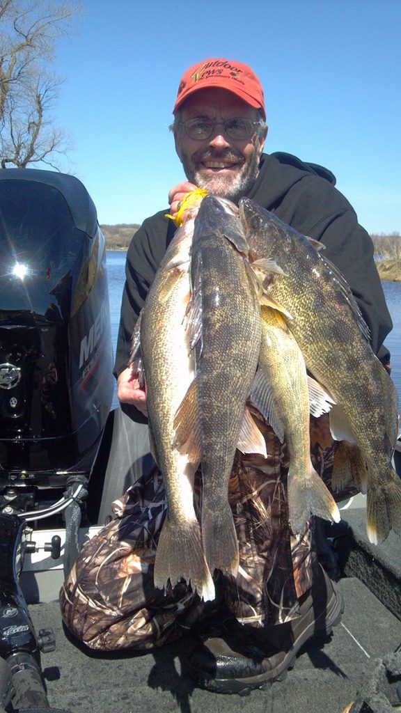 Steve Carney, fishing guide, poses with walleyes he caught on a Minnesota lake